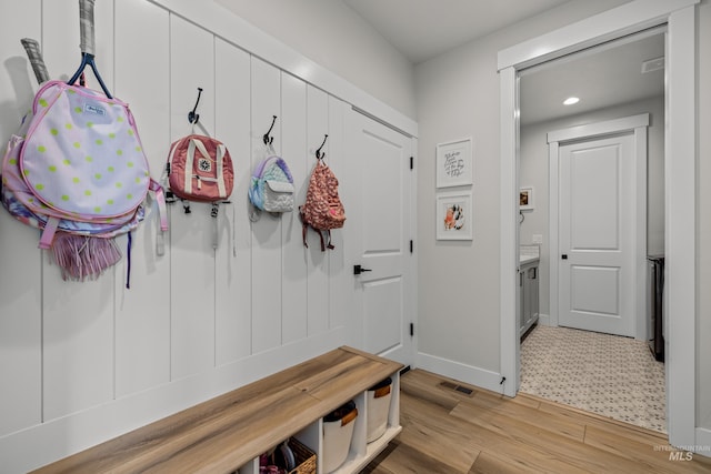 mudroom with light hardwood / wood-style floors