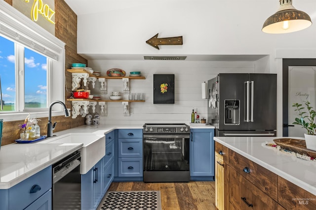 1400 Texas Ridge Rd, Deary, ID 83823 - kitchen with a sink, appliances with stainless steel finishes, blue cabinetry, and dark wood-type flooring
