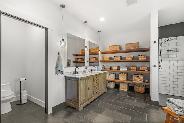 1400 Texas Ridge Rd, Deary, ID 83823 - bathroom featuring a sink, toilet, double vanity, and a tile shower
