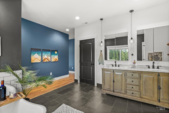 1400 Texas Ridge Rd, Deary, ID 83823 - full bath with a sink, visible vents, baseboards, and double vanity