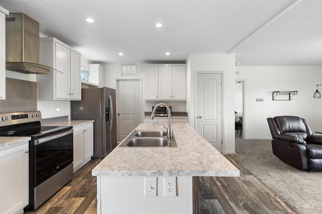 12798 King Rd, Kendrick, ID 83537 - kitchen with stainless steel appliances, a sink, wall chimney exhaust hood, open floor plan, and dark wood finished floors