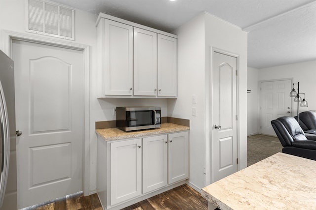 12798 King Rd, Kendrick, ID 83537 - kitchen featuring appliances with stainless steel finishes, light countertops, dark wood-type flooring, and white cabinets