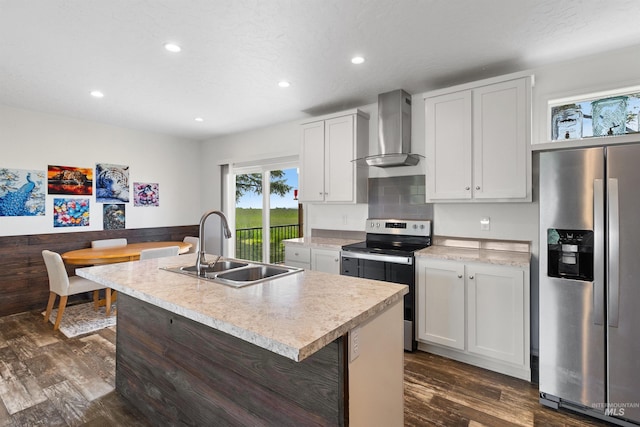 12798 King Rd, Kendrick, ID 83537 - kitchen featuring stainless steel appliances, wall chimney exhaust hood, a sink, light countertops, and recessed lighting