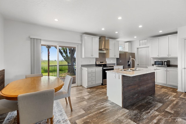12798 King Rd, Kendrick, ID 83537 - kitchen with stainless steel appliances, wall chimney exhaust hood, recessed lighting, dark wood-type flooring, and a sink