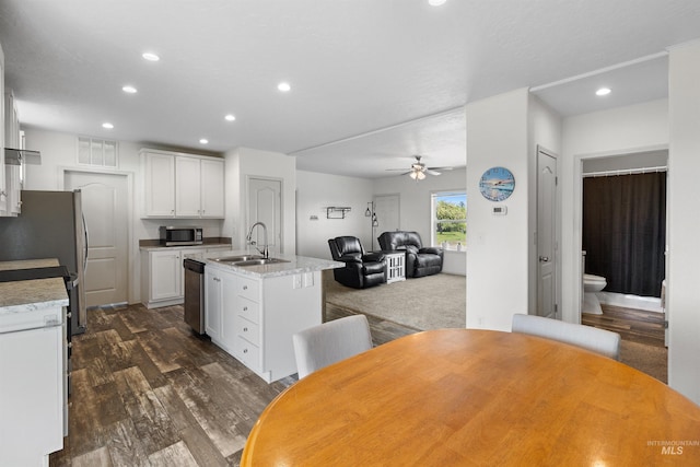 12798 King Rd, Kendrick, ID 83537 - kitchen featuring a sink, stainless steel appliances, dark wood-type flooring, a ceiling fan, and a kitchen island with sink