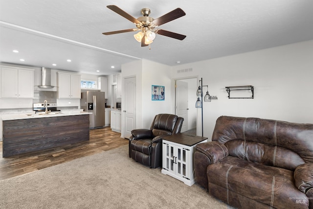 12798 King Rd, Kendrick, ID 83537 - living area featuring ceiling fan, light carpet, light wood-type flooring, and recessed lighting
