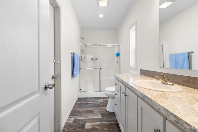 12798 King Rd, Kendrick, ID 83537 - bathroom with a stall shower, wood finished floors, toilet, vanity, and recessed lighting
