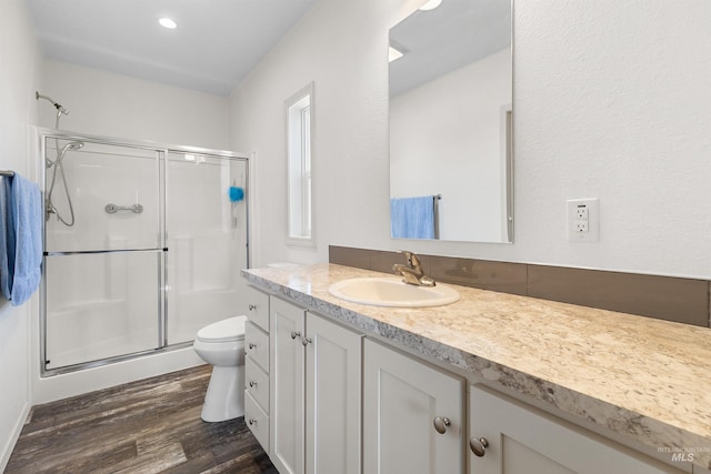 12798 King Rd, Kendrick, ID 83537 - full bathroom featuring a shower stall, wood finished floors, vanity, toilet, and recessed lighting