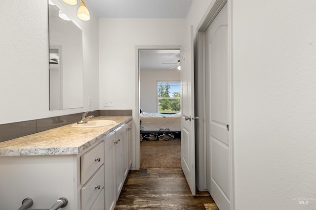 12798 King Rd, Kendrick, ID 83537 - bathroom featuring vanity, wood finished floors, connected bathroom, and a ceiling fan