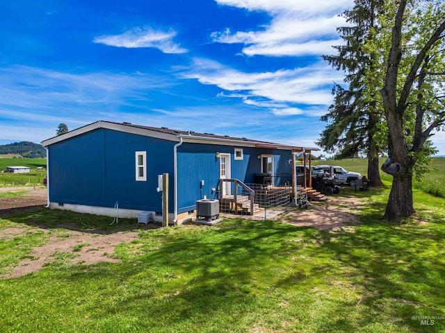 12798 King Rd, Kendrick, ID 83537 - rear view of house with central air condition unit, a lawn, and crawl space