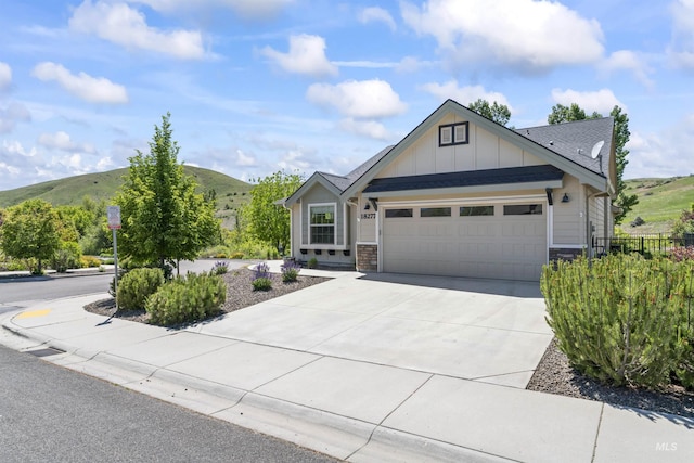 18277 N Streams Edge Way, Boise, ID 83714 - view of front of property featuring a garage, board and batten siding, driveway, stone siding, and a mountain view