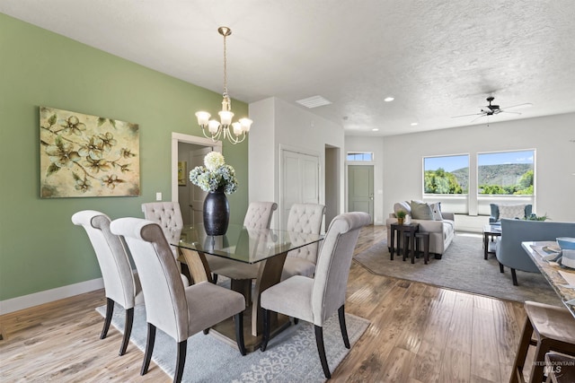 18277 N Streams Edge Way, Boise, ID 83714 - dining room featuring wood finished floors, a chandelier, ceiling fan, baseboards, and recessed lighting