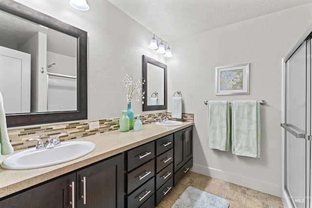 18277 N Streams Edge Way, Boise, ID 83714 - full bathroom with double vanity, decorative backsplash, a textured ceiling, baseboards, and a stall shower