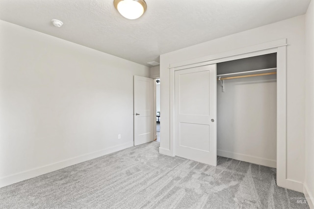 18277 N Streams Edge Way, Boise, ID 83714 - unfurnished bedroom with carpet flooring, a closet, baseboards, and a textured ceiling