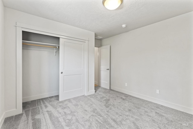 18277 N Streams Edge Way, Boise, ID 83714 - unfurnished bedroom with carpet, a closet, baseboards, and a textured ceiling