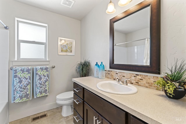 18277 N Streams Edge Way, Boise, ID 83714 - bathroom with vanity, toilet, decorative backsplash, tile patterned floors, and baseboards