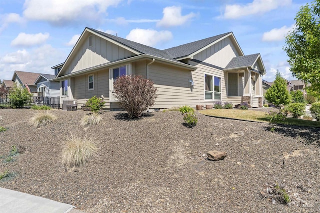 18277 N Streams Edge Way, Boise, ID 83714 - view of side of home with board and batten siding, a shingled roof, and central AC unit