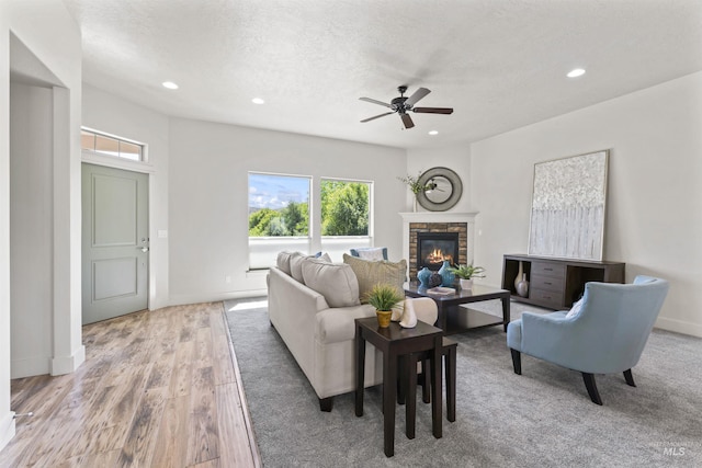 18277 N Streams Edge Way, Boise, ID 83714 - living area featuring a ceiling fan, a stone fireplace, recessed lighting, light wood-type flooring, and baseboards