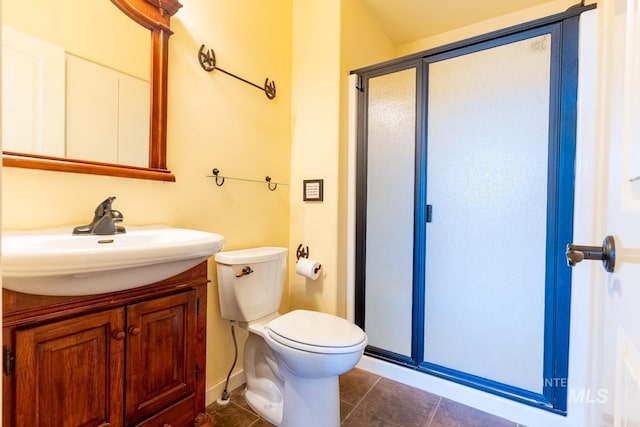 bathroom featuring vanity, tile patterned floors, toilet, and walk in shower