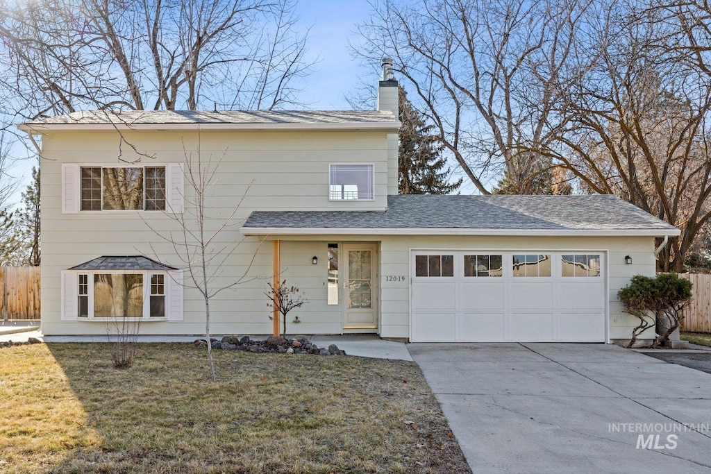 view of front of property featuring a garage and a front lawn