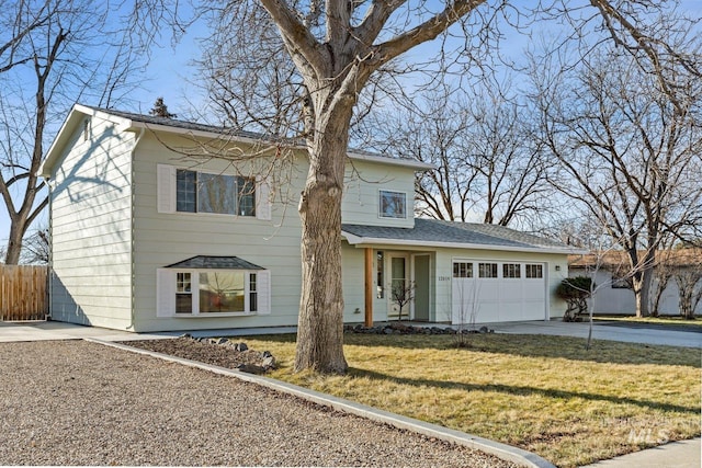 view of front of house featuring a garage and a front lawn