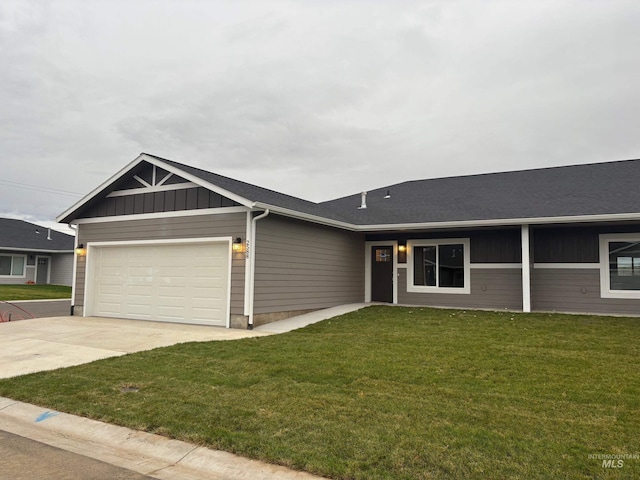 ranch-style house featuring a front yard and a garage