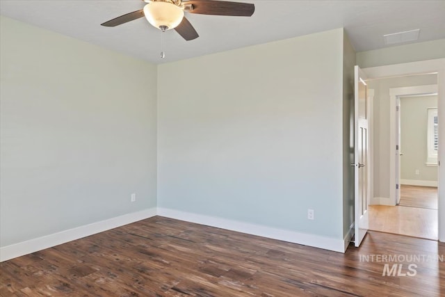 unfurnished room with a ceiling fan, baseboards, and wood finished floors