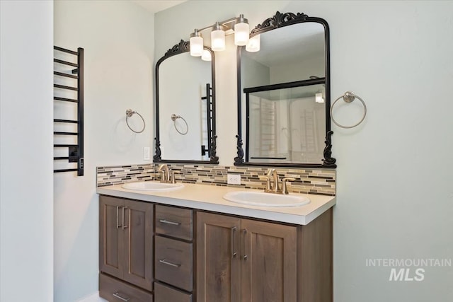 full bathroom with backsplash, double vanity, and a sink