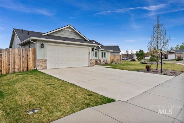 single story home with a front yard, stone siding, concrete driveway, fence, and a garage