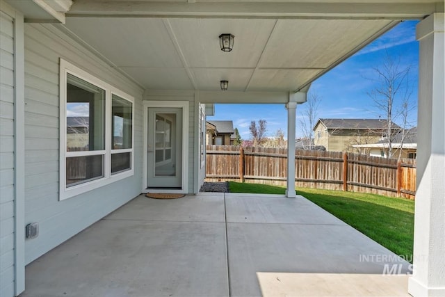 view of patio featuring fence