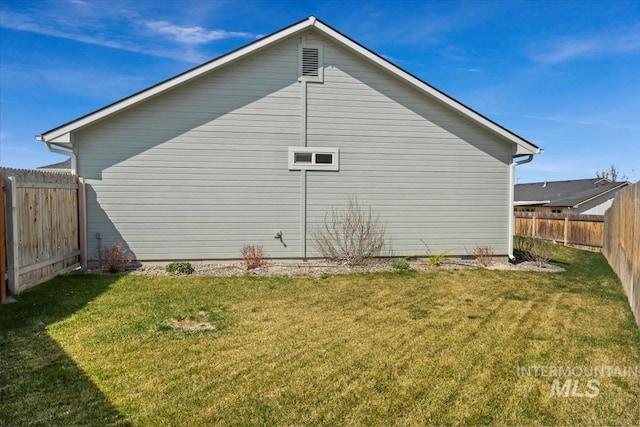 view of home's exterior with a fenced backyard and a yard