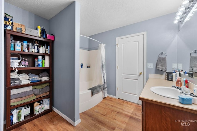 1056 S Hebgon Lake Ave, Middleton, ID 83644 - bathroom with vanity, wood finished floors, shower / bath combination with curtain, and a textured ceiling