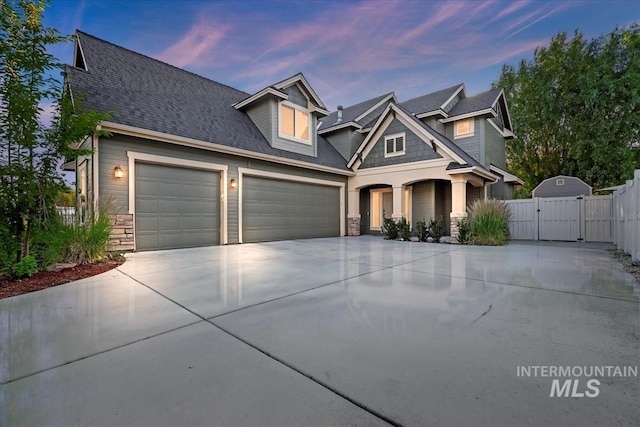 3052 N Christian Way, Meridian, ID 83646 - craftsman-style home featuring stone siding, a gate, driveway, an attached garage, and a shingled roof
