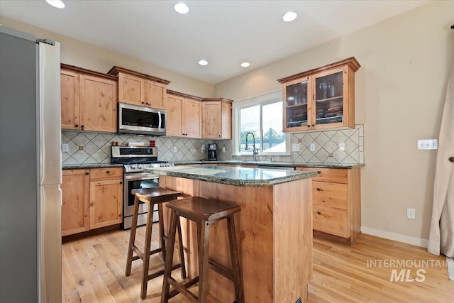 3052 N Christian Way, Meridian, ID 83646 - kitchen featuring stainless steel appliances, light wood finished floors, light brown cabinetry, a kitchen island, and recessed lighting