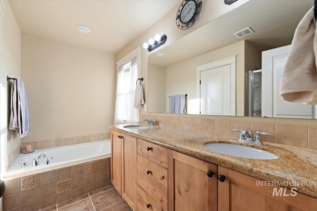 3052 N Christian Way, Meridian, ID 83646 - bathroom featuring a shower stall, a garden tub, double vanity, and tile patterned flooring
