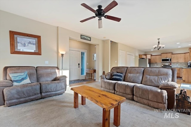 3052 N Christian Way, Meridian, ID 83646 - living room with a chandelier, light carpet, a ceiling fan, and recessed lighting