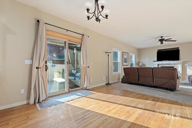 3052 N Christian Way, Meridian, ID 83646 - living area featuring light wood-style flooring, a chandelier, and a ceiling fan