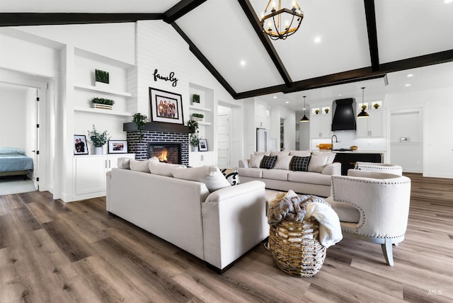 11127 Lake Lowell Ave, Nampa, ID 83686 - living room featuring a fireplace, beamed ceiling, dark wood finished floors, built in shelves, and high vaulted ceiling
