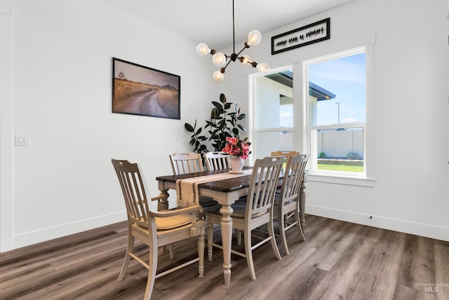 11127 Lake Lowell Ave, Nampa, ID 83686 - dining area featuring wood finished floors, baseboards, and a chandelier