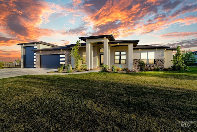 11127 Lake Lowell Ave, Nampa, ID 83686 - view of front facade featuring stone siding, an attached garage, concrete driveway, stucco siding, and a front yard