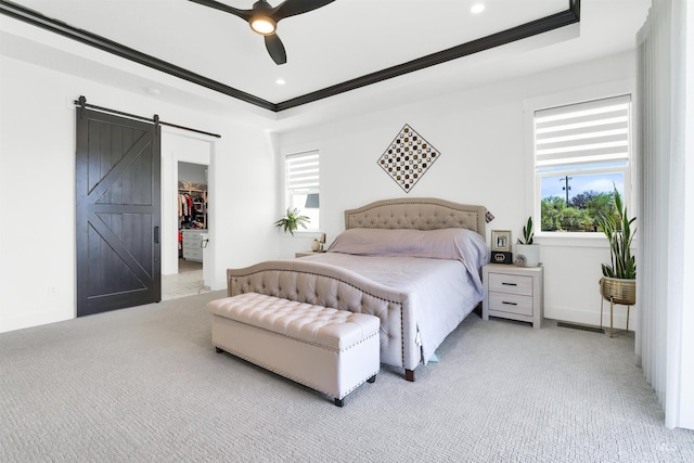 11127 Lake Lowell Ave, Nampa, ID 83686 - bedroom featuring a barn door, multiple windows, a tray ceiling, crown molding, and a walk in closet