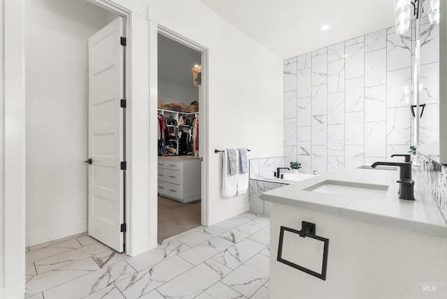 11127 Lake Lowell Ave, Nampa, ID 83686 - full bathroom with marble finish floors, a walk in closet, tile walls, recessed lighting, and vanity