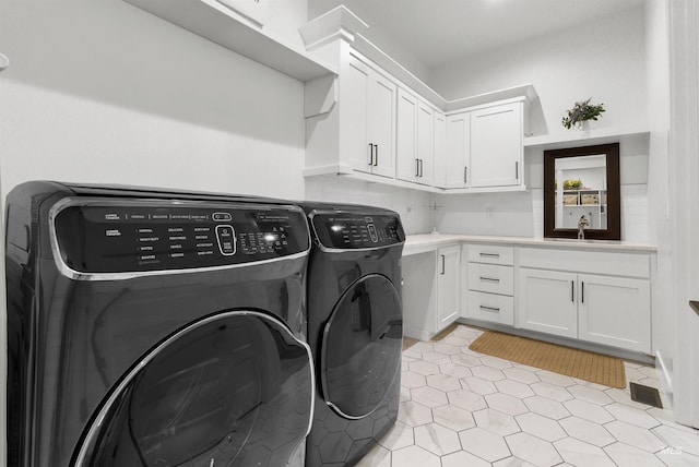 11127 Lake Lowell Ave, Nampa, ID 83686 - laundry room with washing machine and clothes dryer, cabinet space, and light tile patterned floors