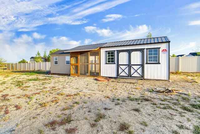 11127 Lake Lowell Ave, Nampa, ID 83686 - view of outbuilding featuring fence, an outbuilding, and a sunroom