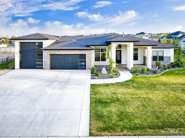 11127 Lake Lowell Ave, Nampa, ID 83686 - view of front of house featuring an attached garage, driveway, a front lawn, roof with shingles, and stucco siding