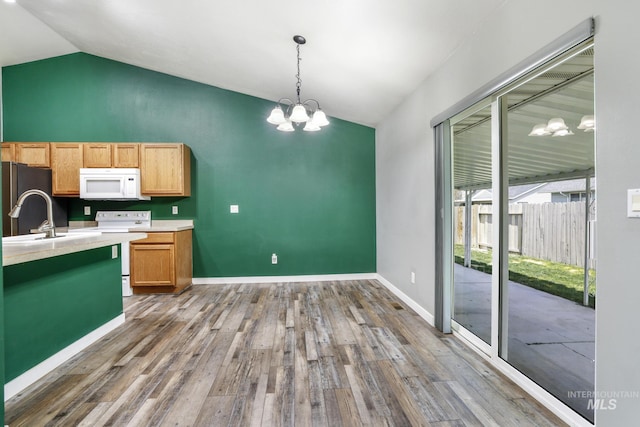 224 Paintbrush Cir, Twin Falls, ID 83301 - kitchen featuring white appliances, lofted ceiling, a chandelier, wood finished floors, and light countertops