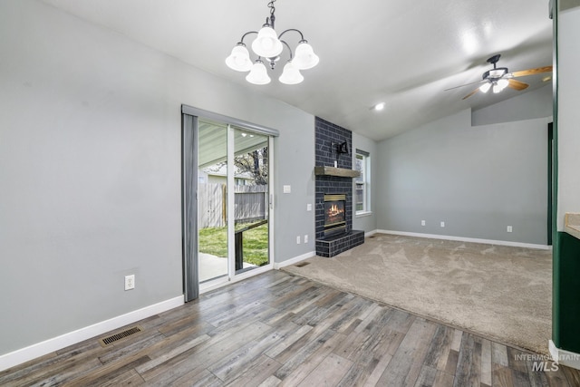 224 Paintbrush Cir, Twin Falls, ID 83301 - unfurnished living room with a fireplace, wood finished floors, lofted ceiling, baseboards, and a chandelier