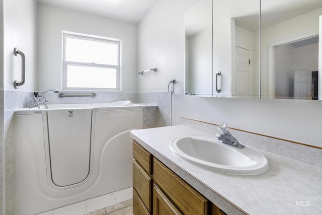 224 Paintbrush Cir, Twin Falls, ID 83301 - full bath with vanity, a bath, tile walls, wainscoting, and tile patterned floors