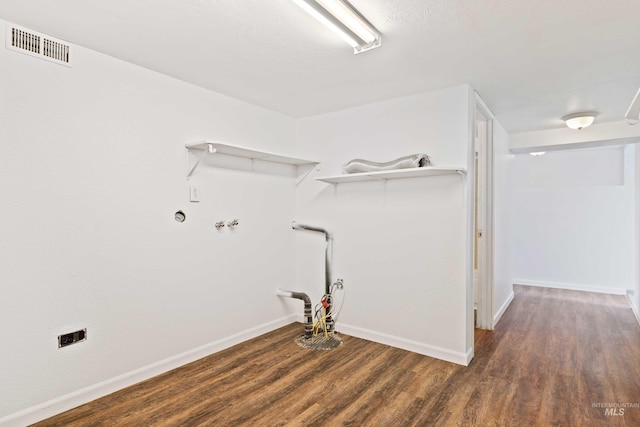 laundry room featuring laundry area, washer hookup, wood finished floors, visible vents, and baseboards