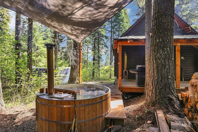 1221 Fox Rd, Cascade, ID 83611 - view of patio / terrace with a hot tub, a grill, and a deck